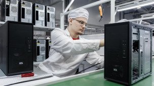 Сотрудники на линии сборки продукции на заводе по производству компьютерной техники