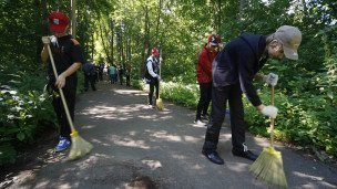 Школьники подметают тропинку на уроке трудового воспитания