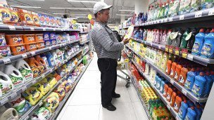 Мужчина в отделе бытовой химии в супермаркете