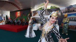 Участницы узбекского национального ансамбля выступают на стенде "Узбекистан"