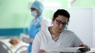 Врач смотрит историю болезни в больнице скорой медицинской помощи