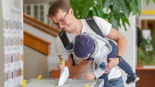 Избиратель голосует на выборах вместе со своим ребенком