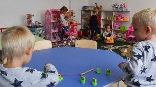 Дети в саду играют в игрушки 