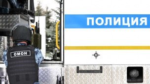 Сотрудник правоохранительных органов возле автомобиля полиции