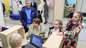Многодетная семья у информационной стойки