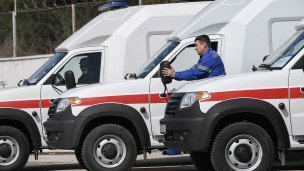 Сотрудники скорой помощи рядом с новыми автомобилями