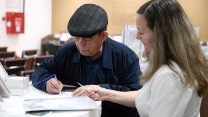 Мужчина заполняет документы