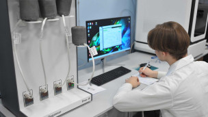 Студент за ноутбуком в лаборатории