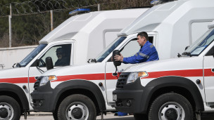 Сотрудники скорой помощи рядом с новыми автомобилями