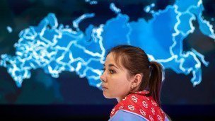 Девушка у стенда на фоне карты РФ