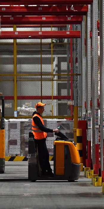 Сотрудники на автокаре в распределительном центре компании X5 Retail Group 