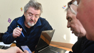 Люди старшего возраста с телефоном и ноутбуком 